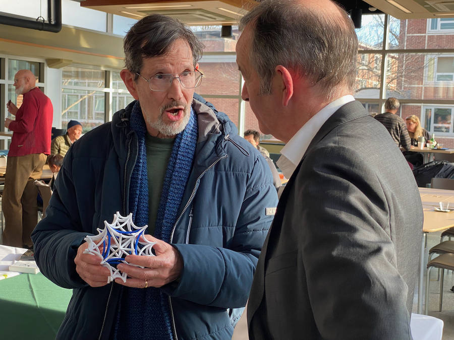 Professor Feingold showing Professor Bridson his 3D-printed geometric model